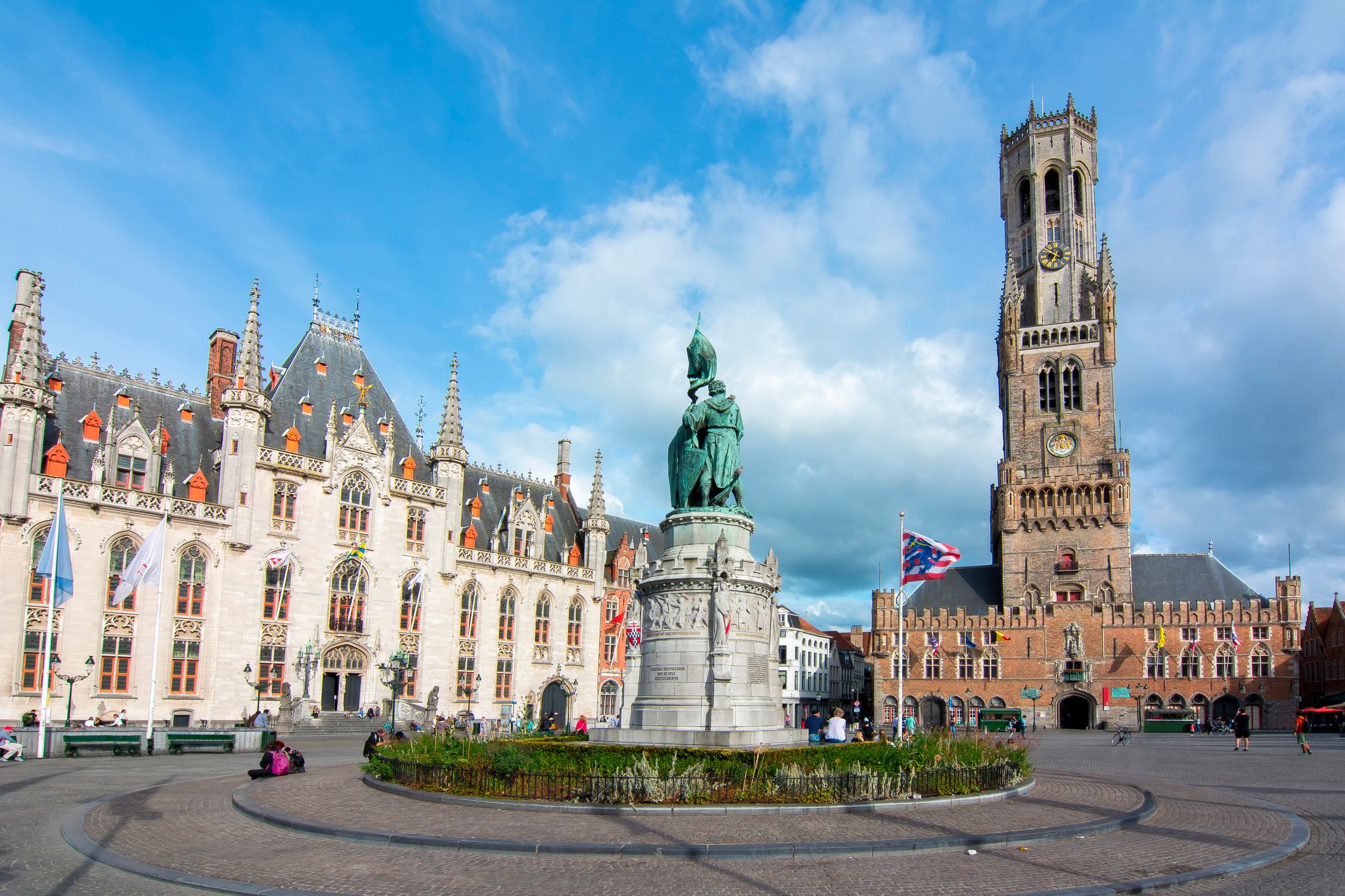 Photo of market square (Grote markt) and Belfort tower in Bruges, Belgium.