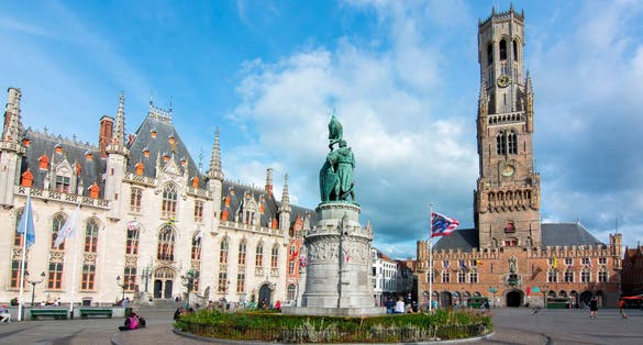 Photo of market square (Grote markt) and Belfort tower in Bruges, Belgium.