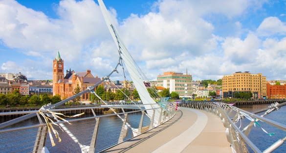 photo of view of Urban skyline of Derry city (also called Londonderry) in northern Ireland with the famous "Peace Bridge" (Europe - Northern Ireland).