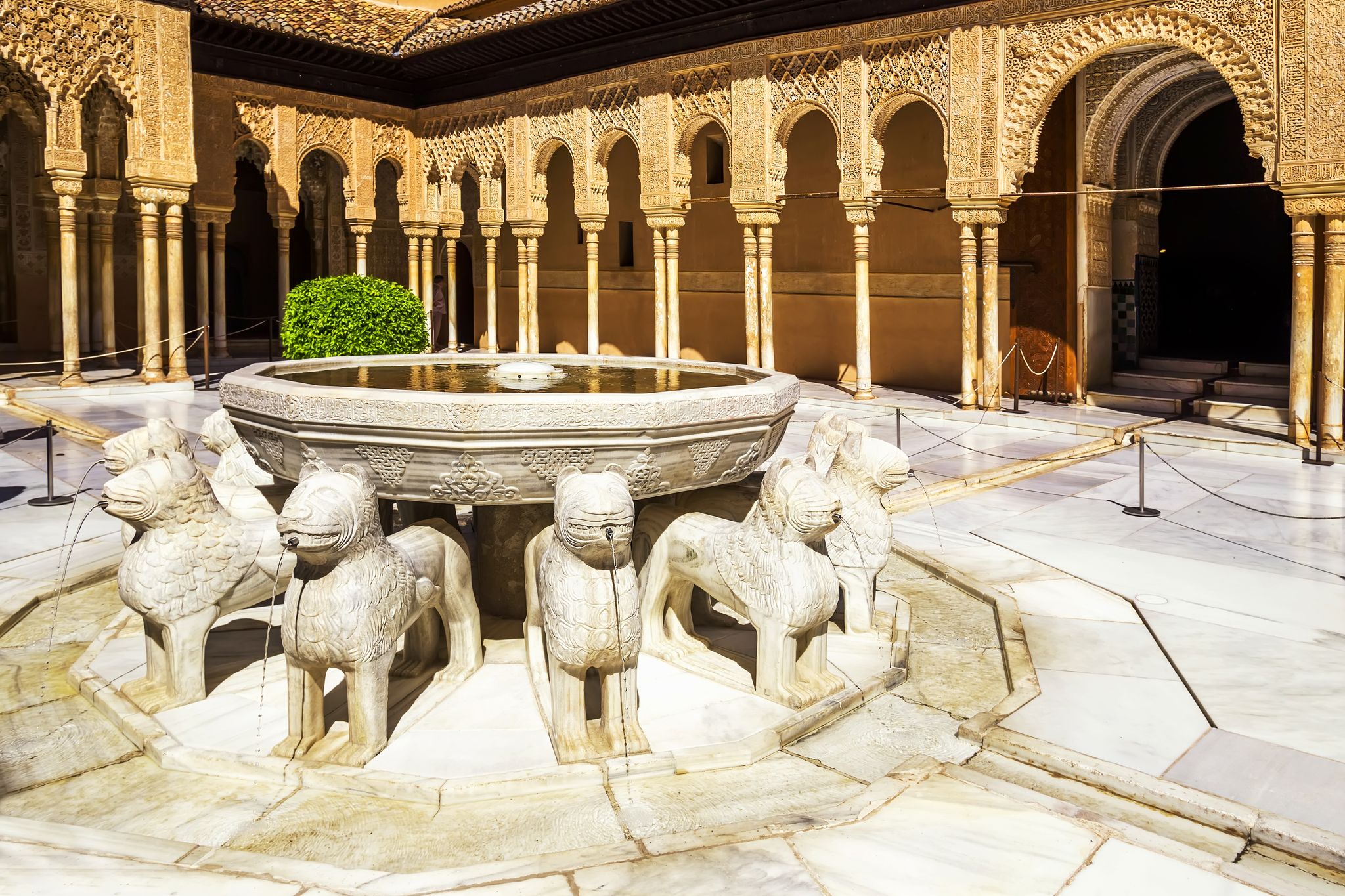 Photo of Patio de los Leones inside of the Nasrid palace of Alhambra fortress in Granada, Spain.