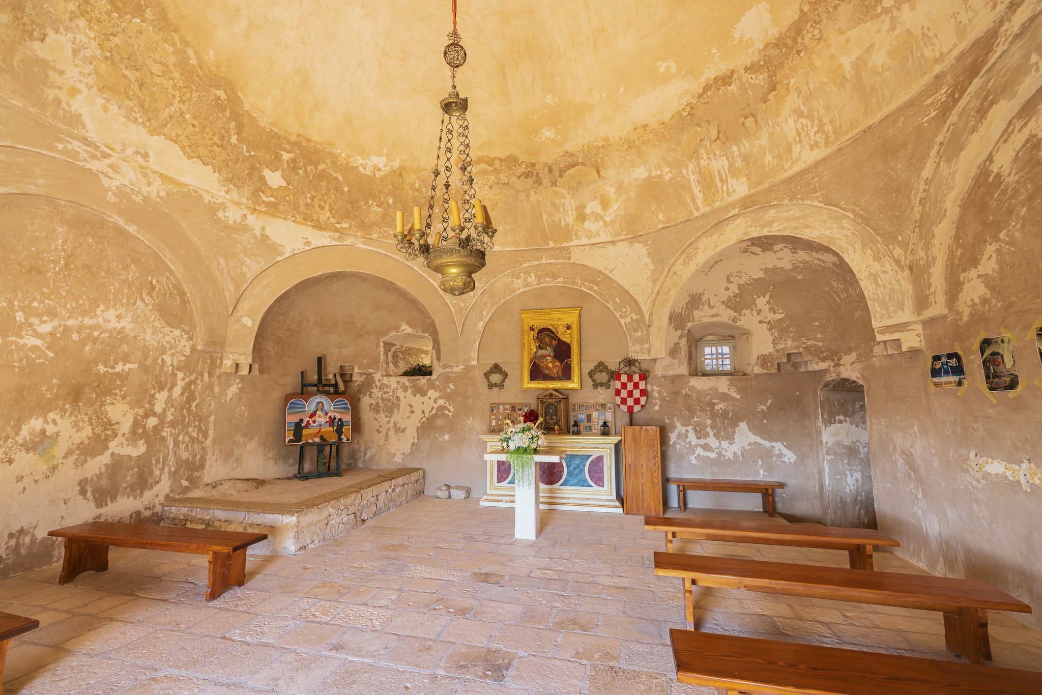 Photo of The altar and some artwork in St. Vitus church inside the Klis fortress, a converted mosque, Croatia.