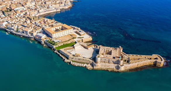 Siracusa, Ortigia Island from the air, Sicily, Italy. Isola di Ortigia, coast of Ortigia island at city of Syracuse, Sicily, Italy. Coastline town Syracuse, Sicily and old Ortigia island. Aerial view.