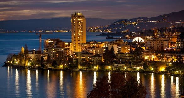 Night cityscape of Montreux Switzerland with land and ferris wheel.