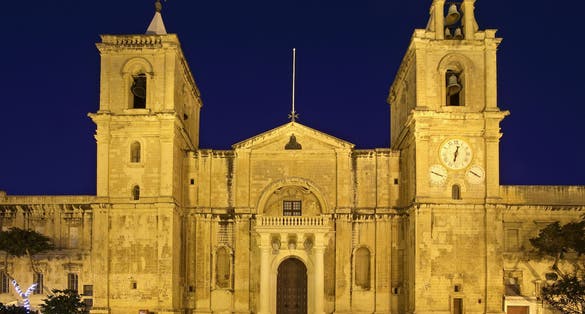 Photo of exterior view of Saint John's Co-Cathedral at night in Valletta, Malta.
