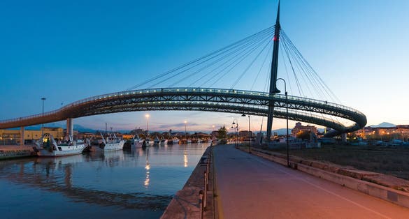 The Ponte del Mare monumental bridge and the Ferris wheel at the dusk, in the canal and port of Pescara city, Abruzzo region