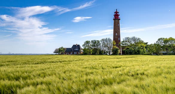 Photo of The beautiful Lighthouse Of Flügge On The Isle Of Fehmarn at the Baltic Sea in Germany. Summer in Germany.