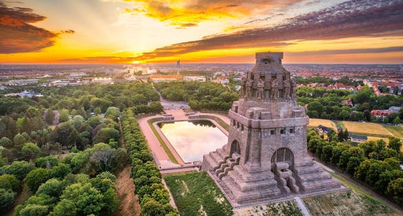 Photo of panoramic view over the city of Leipzig with the Monument to the Battle of the Nations at sunset.