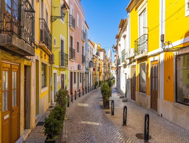 Colorful cobbled street in Setubal glowing in summer light, a charming city to explore in Portugal in August..jpg