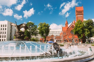 Photo of church of Saints Simon And Helen or Red Church And Fountain At Independence Square In Minsk.