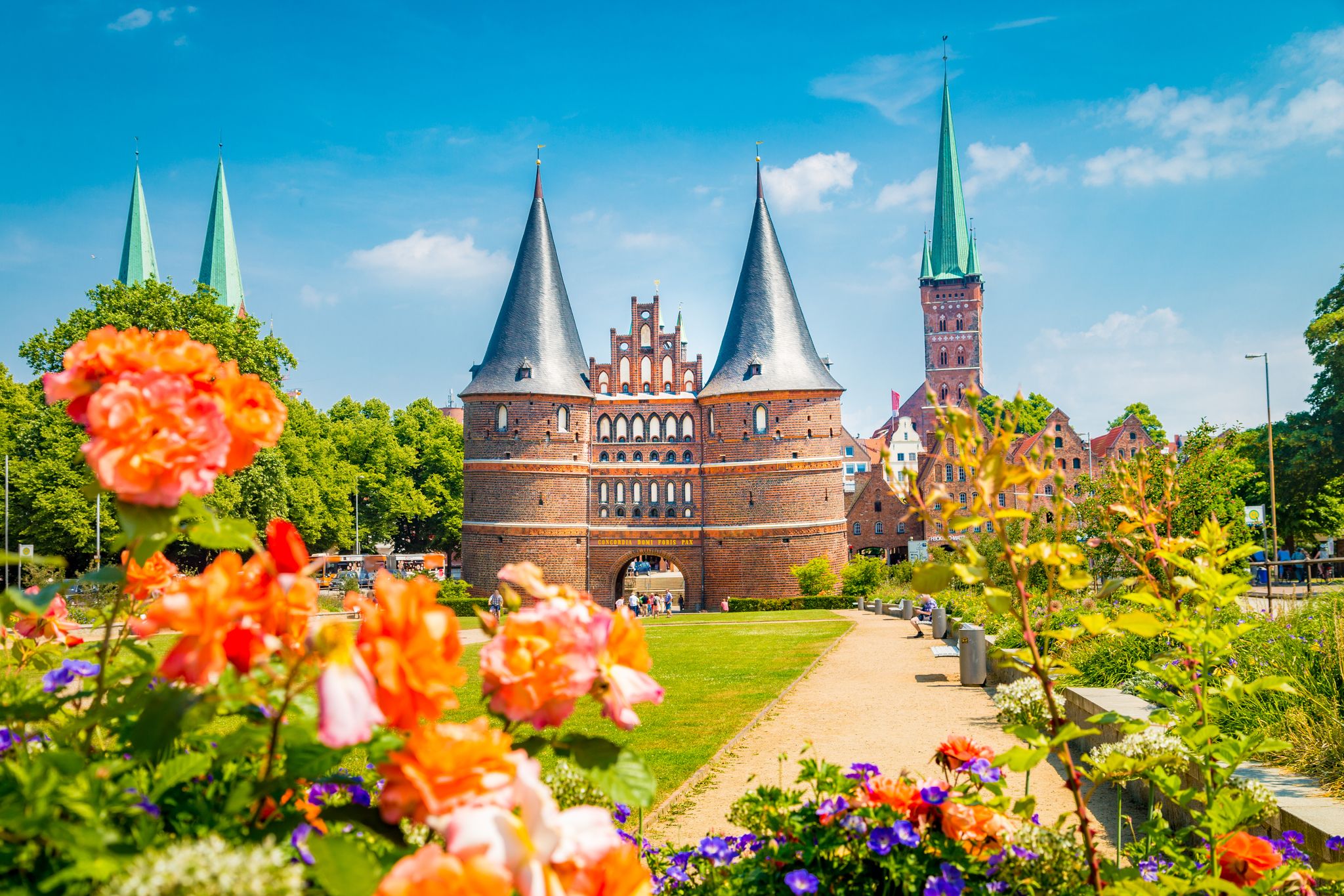 view of the historic town of Lübeck with famous Holstentor town gate on a beautiful sunny day with blue sky and clouds in summer, Schleswig-Holstein, northern Germany
