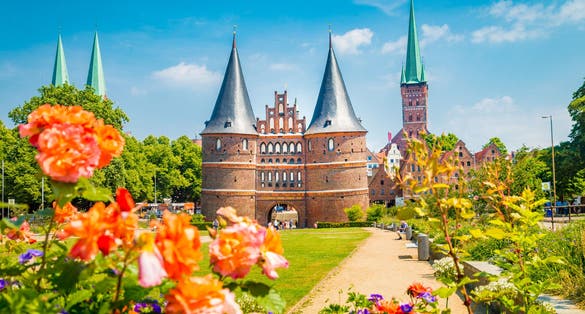 view of the historic town of Lübeck with famous Holstentor town gate on a beautiful sunny day with blue sky and clouds in summer, Schleswig-Holstein, northern Germany