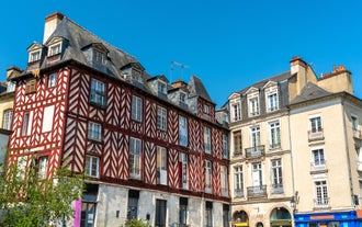 Photo of traditional half-timbered houses in the old town of Rennes, Brittany, France.