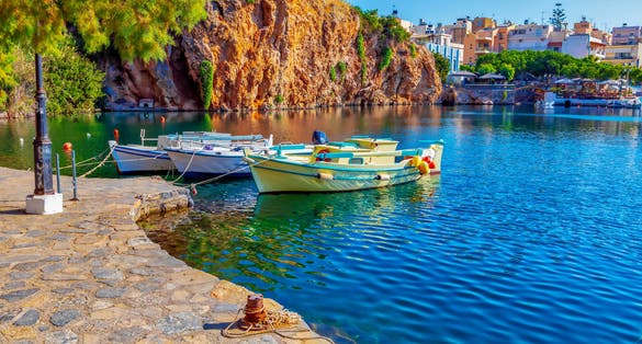 Photo of fishing boats on the Voulismeni lake in Agios Nikolaos, Crete island, Greece.