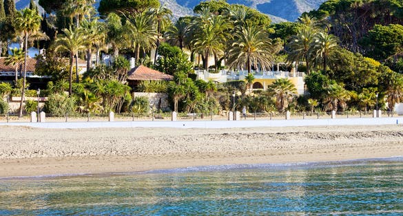 Photo of Marbella sandy beach coastline summer holiday scenery by the Mediterranean Sea in Spain,  Malaga province.