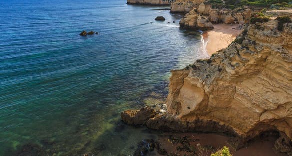 Beach Praia dos Beijinhos summer evening view. Atlantic coast landscape (Lagoa, Algarve, Portugal).