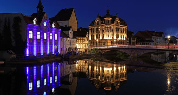 Photo of illuminated downtown and reflection on the river Werra in Eschwege