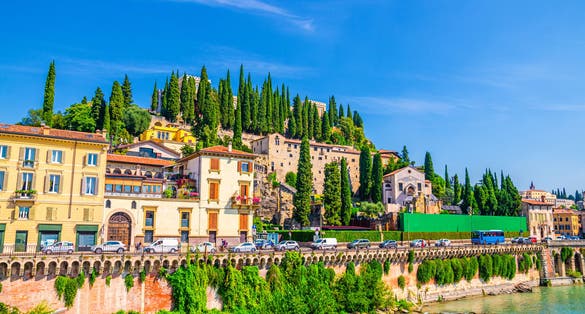 Castel San Pietro St. Peter Castle, Museo Archeologico, Convento di San Girolamo on hill with cypress trees and Adige river in Verona city historical centre, blue sky, Veneto Region, Northern Italy.