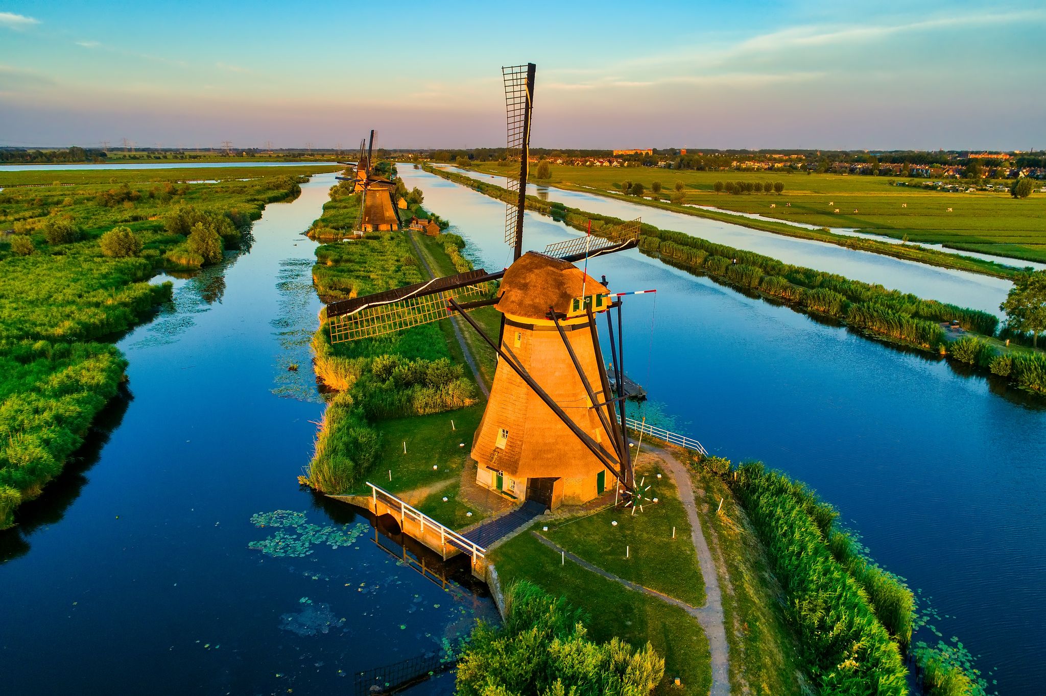 photo of aerial view of traditional windmills Nederwaard Molen No5 in Kinderdijk, The Netherlands. This system of 19 windmills was built around 1740 and is a UNESCO heritage site.