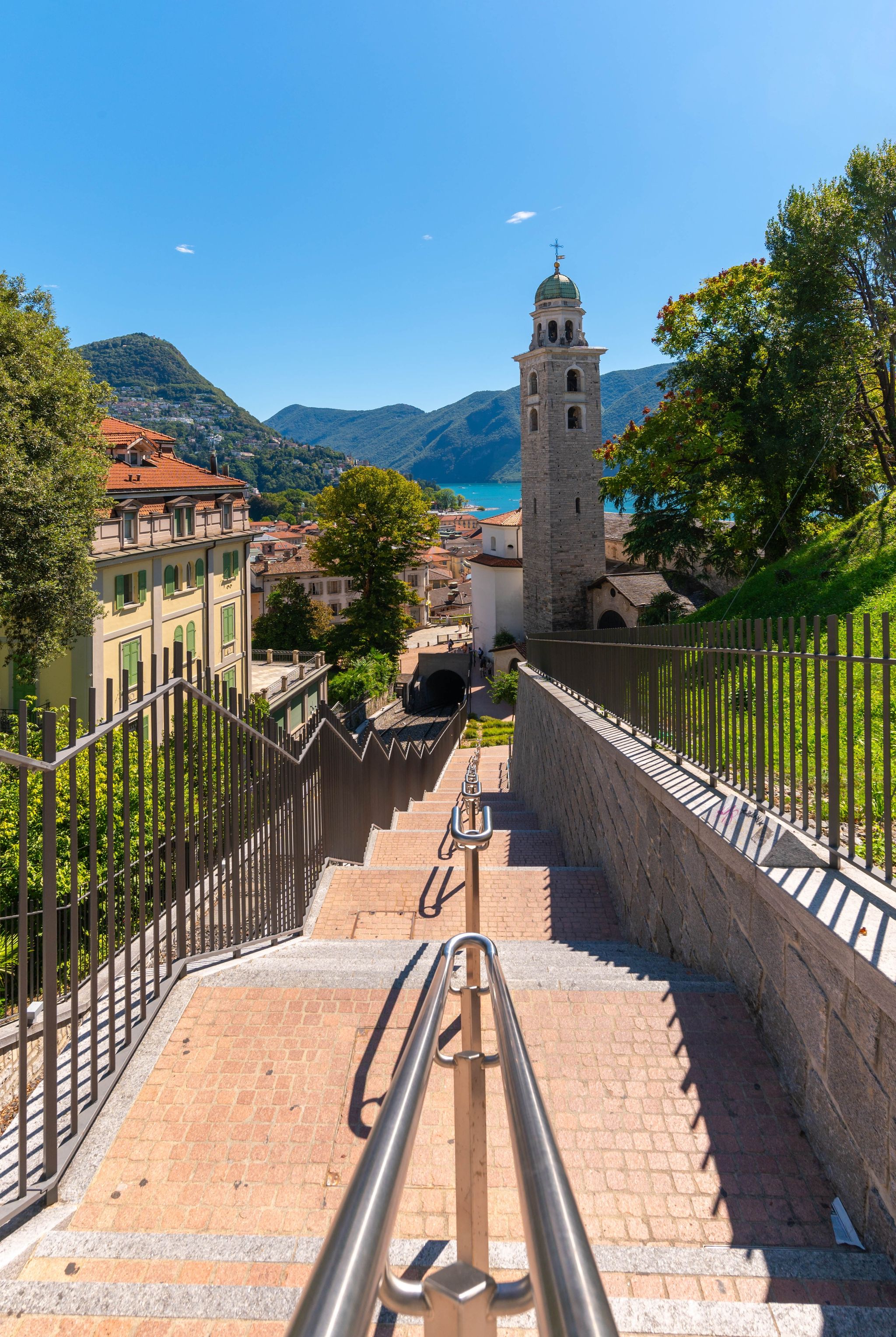photo of Lugano with the Cathedral of San Lorenzo and Monte Bré in Switzerland.
