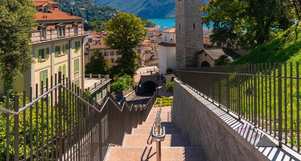 photo of Lugano with the Cathedral of San Lorenzo and Monte Bré in Switzerland.