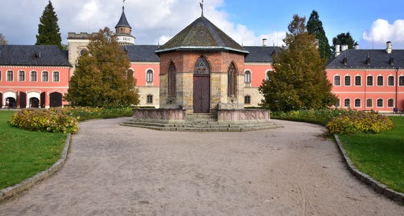 Photo of Sychrov Castle with typical pink facade. Neo-Gothic style chateau with beautiful english style park. Bohemian Paradise, Czech Republic.