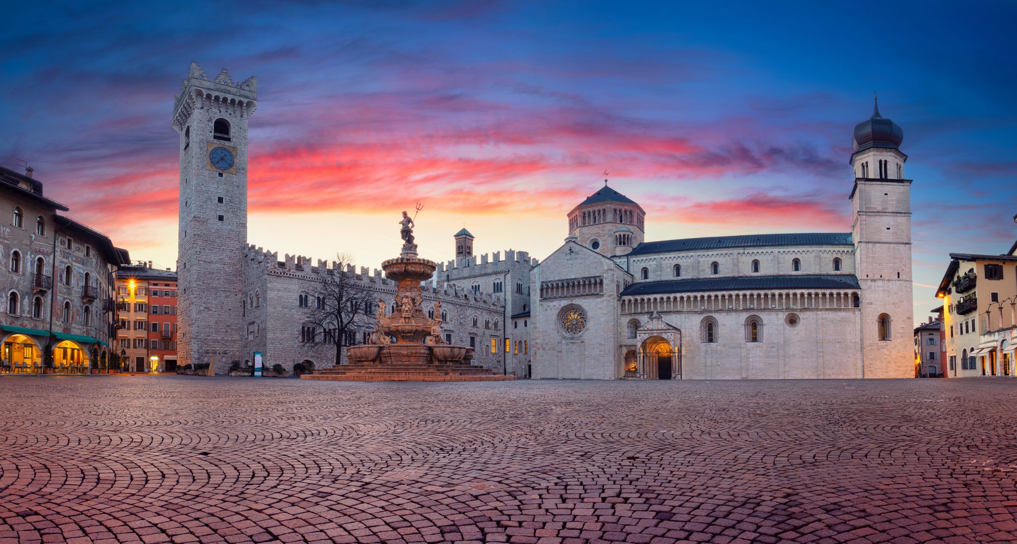 Trento, Italy. Panoramic cityscape image of Duomo Square with Trento Cathedral and the Fountain of Neptune located in historical city of Trento, Trentino, Italy during beautiful sunrise.