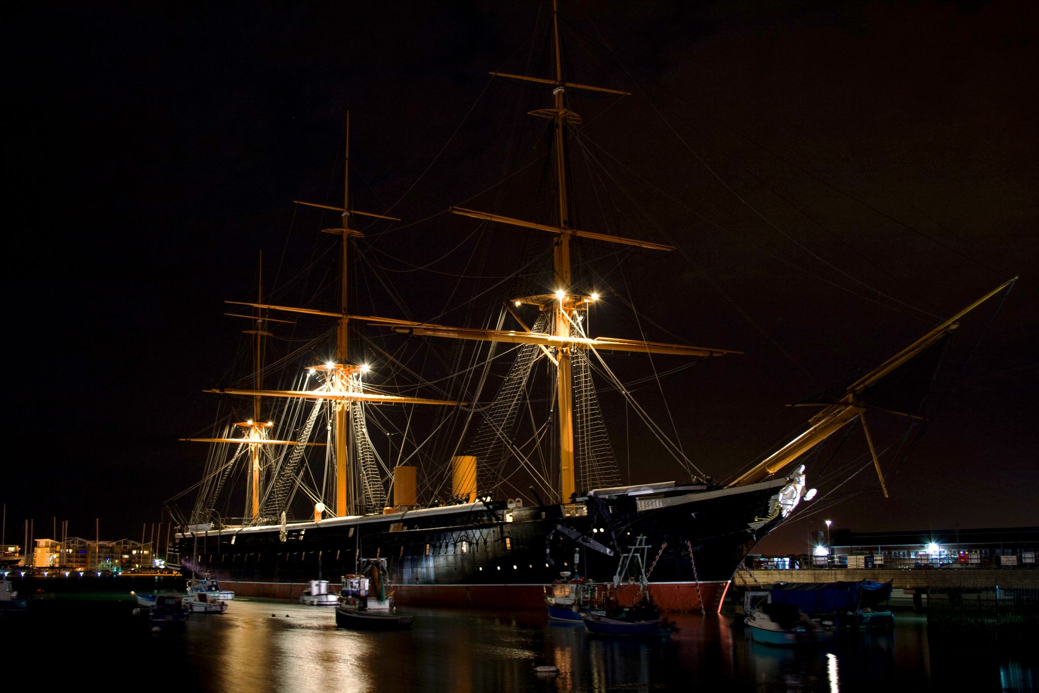 Photo of HMS Victory the Admiral Horatio Nelson's flagship at night at the Battle of Trafalgar in 1805 at Portsmouth Historic Dockyard, UK.