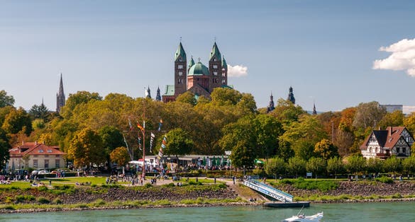 Photo of scenic view over the Rhine to the cathedral of Speyer, Germany.