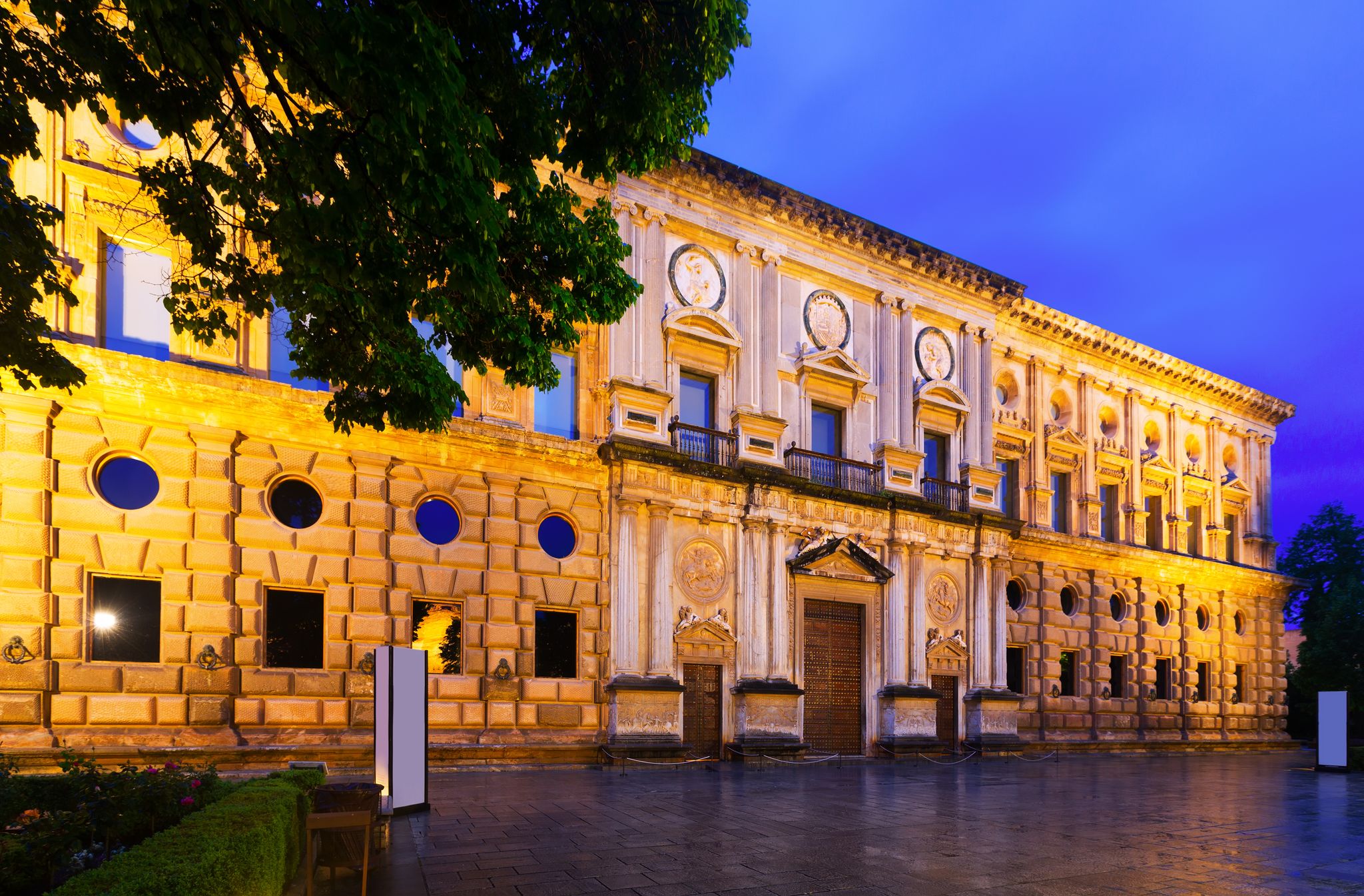 Photo of Evening view of Facade of the Palace of Charles V at Alhambra. Granada, Spain .