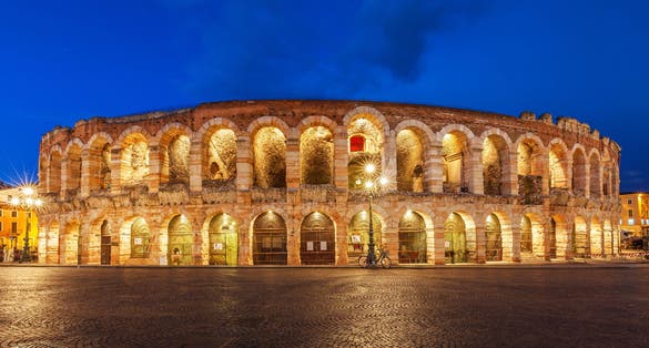 photo of verona, Italy. ancient amphitheater arena di verona in Italy like Rome coliseum with nighttime illumination and evening blue sky. verona's italian famous ancient landmark theatre. veneto region.