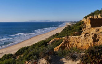Photo of aerial view of Costa da Caparica coastline of glorious sandy beaches, powerful Atlantic waves, Portugal.