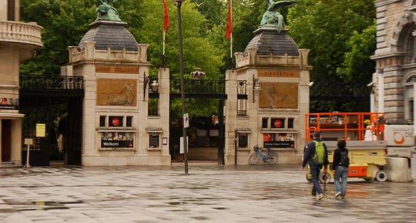 Photo of entrance door to Antwerp Koningin Astridplein. Pelican and statue eagle in bronze above the towers, Belgium.