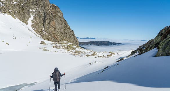 Person walking on the snowy slopes in French Alps near Grenoble