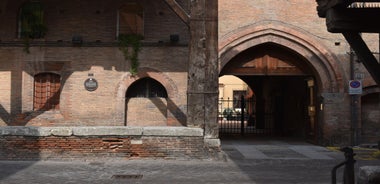 Photo of Italy Piazza Maggiore in Bologna old town tower of town hall with big clock and blue sky on background, antique buildings terracotta galleries.