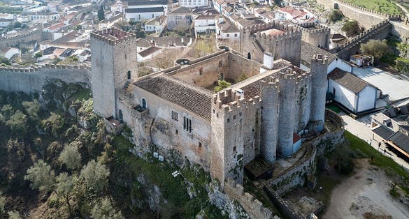 Photo of aerial view of Stone masonry Castle of Obidos and wall ruins or Castelo de Óbidos is a well-preserved medieval castle located in the civil parish of Santa Maria, Portugal.