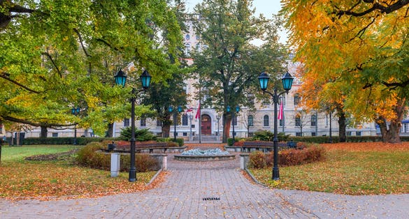 Entrance door to a major building of Latvian State University is seen through the public botanical park
