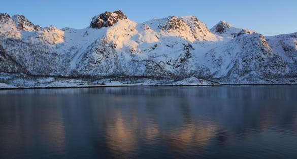 photo of view of Winter in Raftsund between the Norwegian archipelagos of Lofoten and Vesteralen. View from a cruise ship between Stokmarknes and Svolvaer in the Raftsund at sunset.