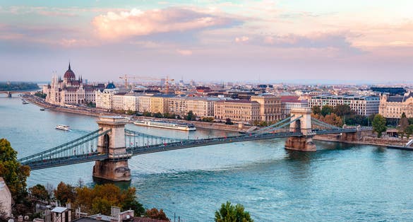 Photo of the river Danube, the Chain Bridge and the Pest skyline in Budapest, Hungary.
