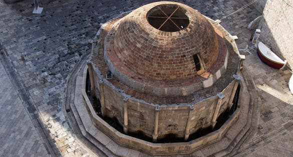 Photo of aerial view of large Onofrio Fountain on the Square at Stradun Street in the Old city of Dubrovnik, Croatia.