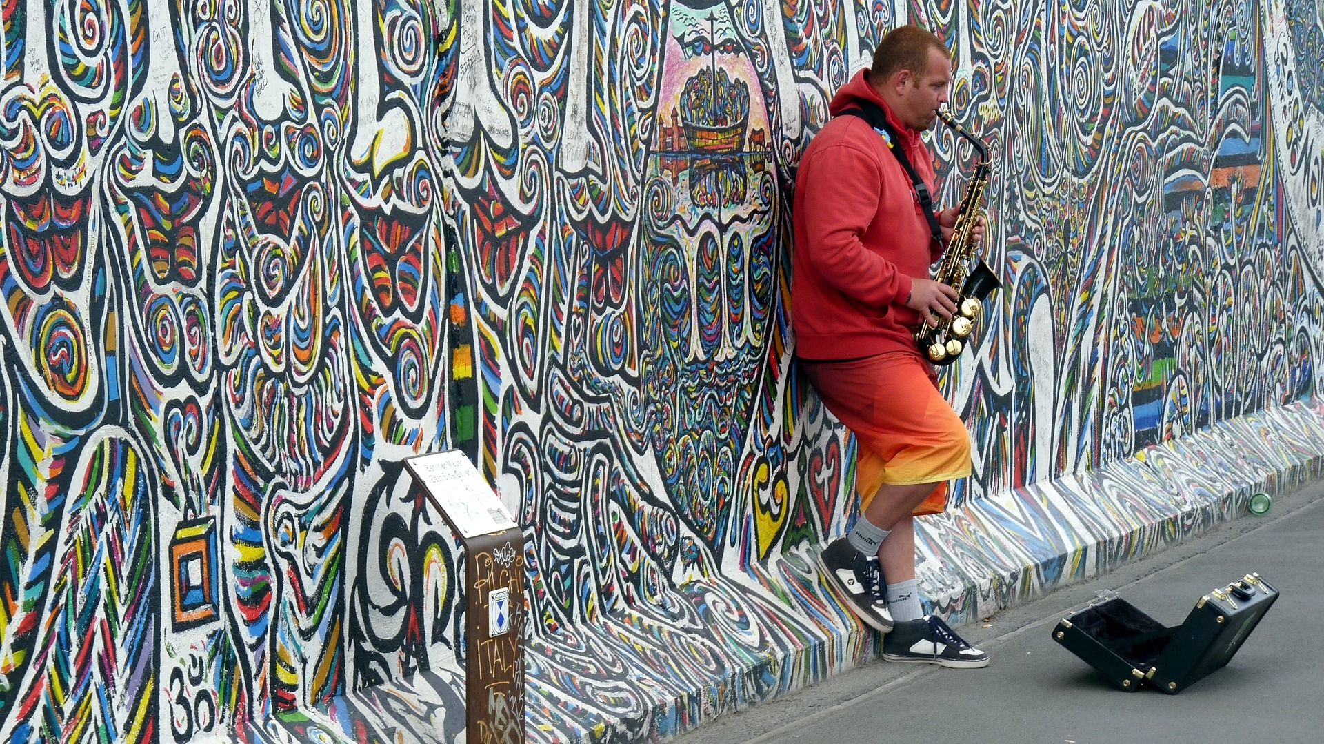 Photo of musician at Graffiti at the East Side Gallery Berlin, Germany ,the East Side Gallery is the longest preserved stretch of the Berlin wall.