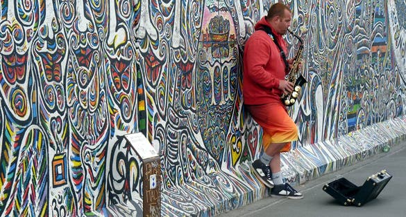 Photo of musician at Graffiti at the East Side Gallery Berlin, Germany ,the East Side Gallery is the longest preserved stretch of the Berlin wall.