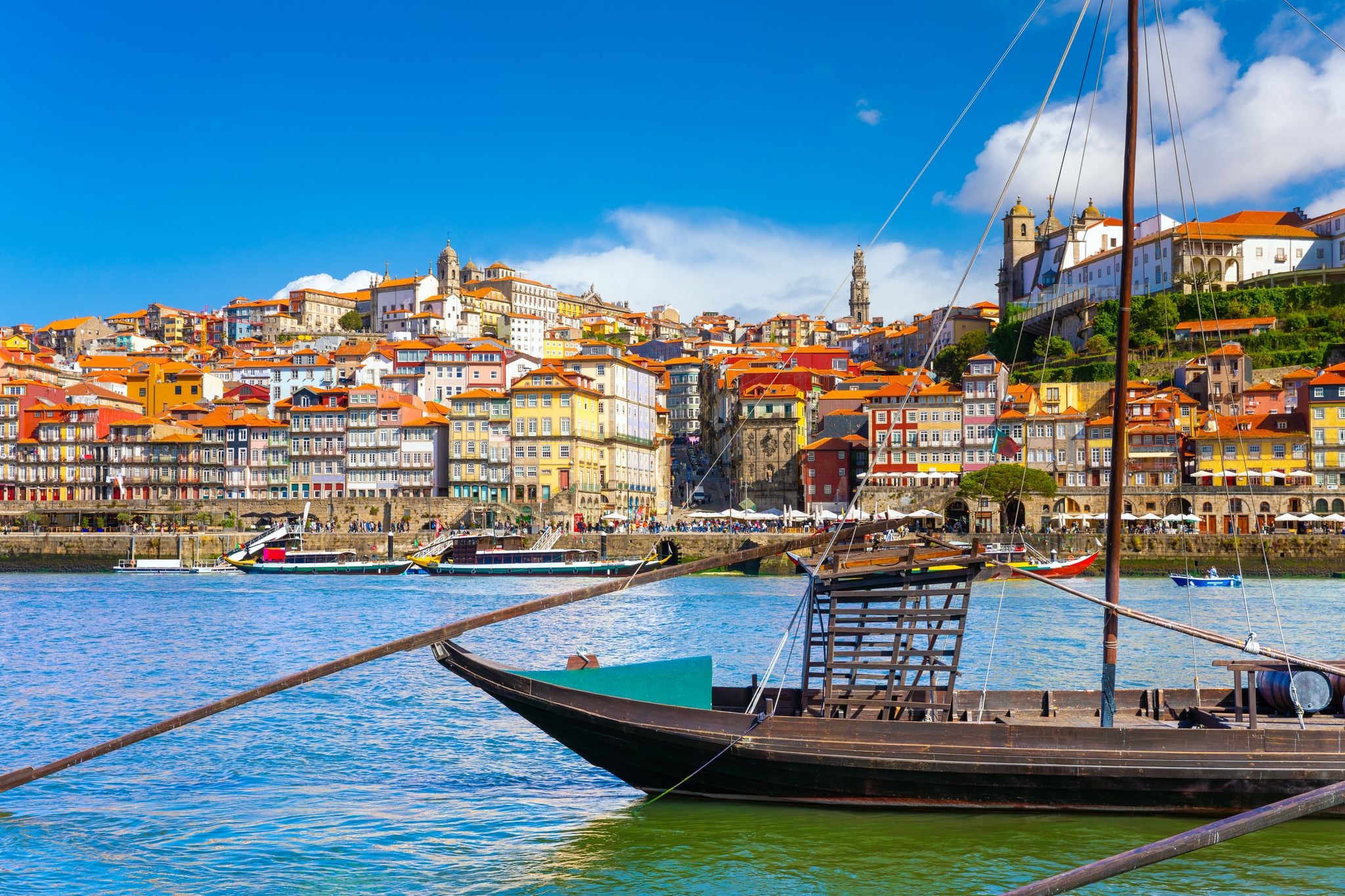 Porto, Portugal old town ribeira aerial promenade view with colorful houses, Douro river and boats.