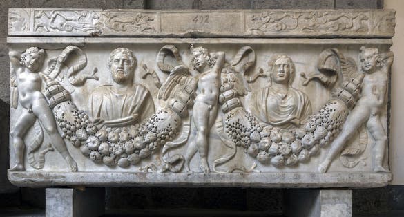 photo of NAPLES, ITALY - JULY 22 2015: 4th century AD Roman sarcophagus depicting the legend of Prometheus creating the first man on display in the Naples National Archaeological Museum.