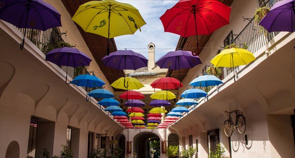 Colourful umbrellas in an alleyway on a sunny day in central Kosice in Slovakia.
