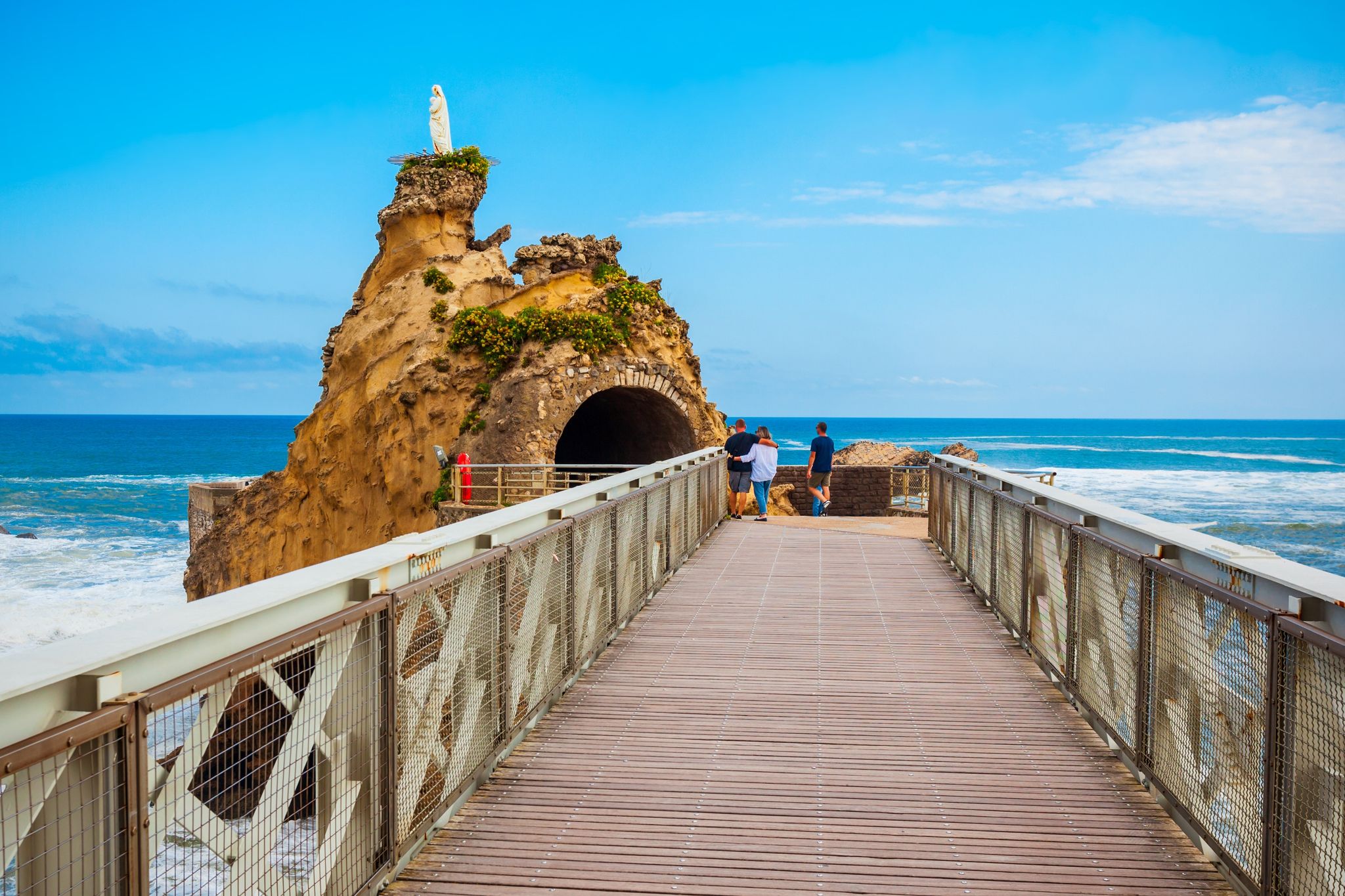 photo of people visiting the Rocher de la vierge in Biarritz, France.