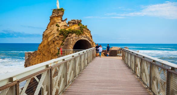 photo of people visiting the Rocher de la vierge in Biarritz, France.