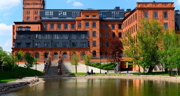 Photo of Lodz city in central Poland know for textile manufacturing, historic textile factory transformed into residential apartments buildings.