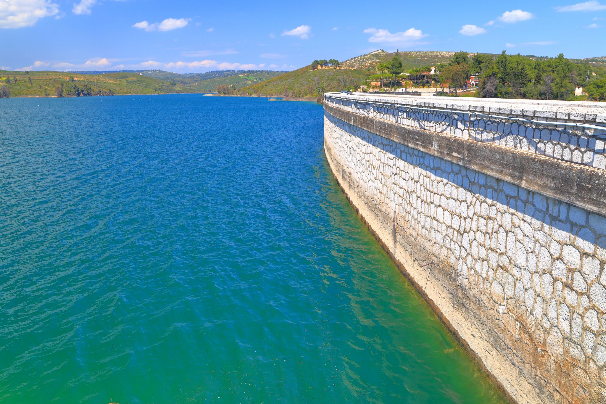 photo of view of Stone dam encloses the Marathon lake, Greece.