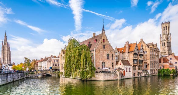 Panoramic city view with Belfry tower and famous canal in Bruges, Belgium.