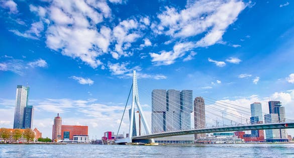 Photo of attractive view of Renowned Erasmusbrug (Swan Bridge) in Rotterdam in front of Port and Harbour.